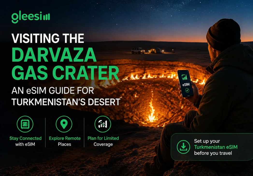 Traveler using a Turkmenistan eSIM while visiting the Darvaza Gas Crater in the Karakum Desert with remote travel connectivity.